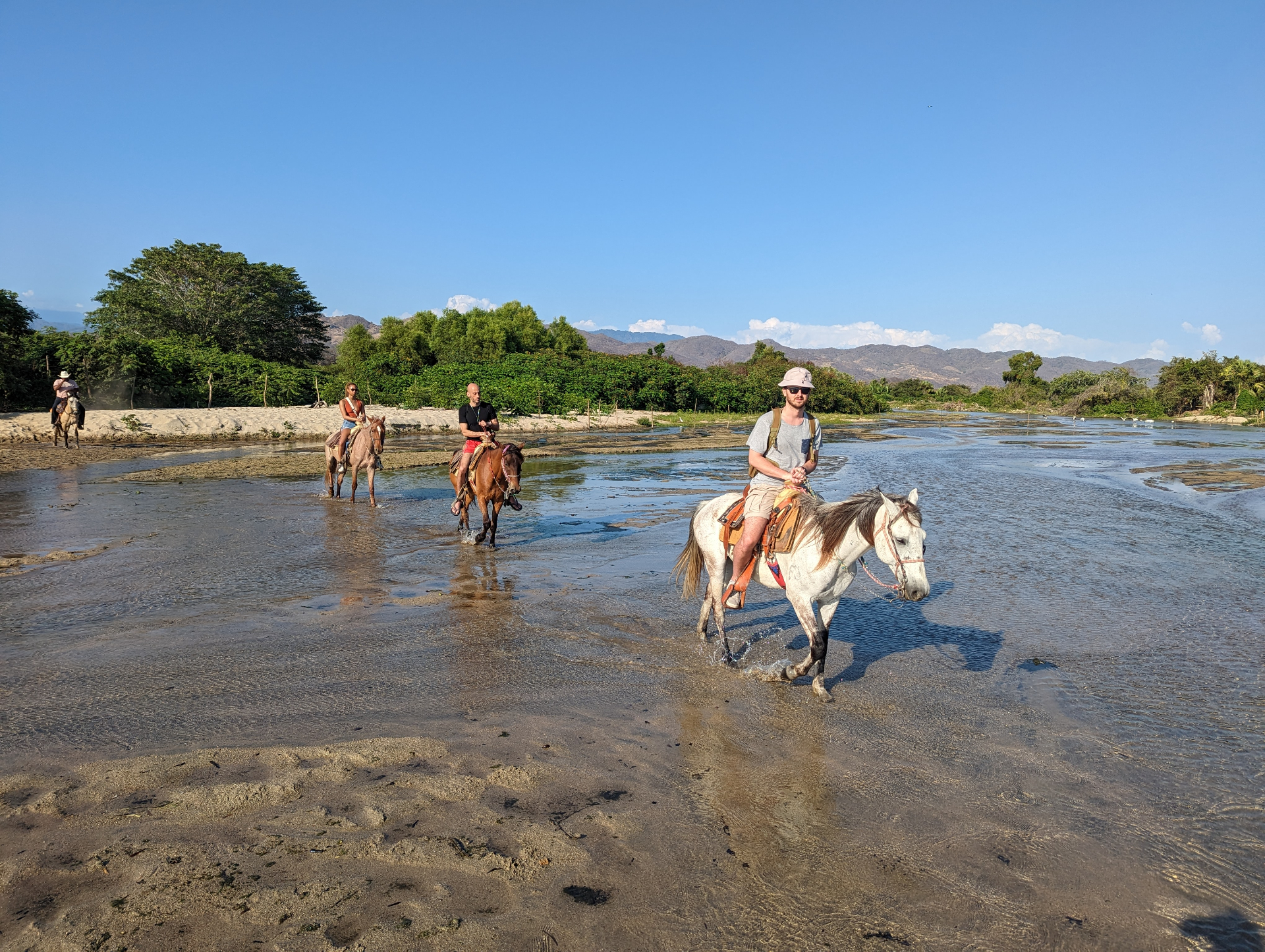 Horses crossing a shallow river in Puerto Escondido